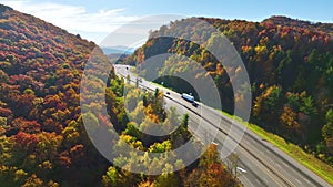 Aerial view of I-40 freeway in North Carolina heading to Asheville through Appalachian mountains in golden fall with