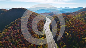 Aerial view of I-40 freeway in North Carolina heading to Asheville through Appalachian mountains in golden fall with