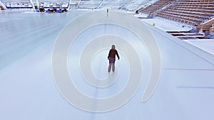 Aerial view of ice skating woman outdoor, ice rink Medeo