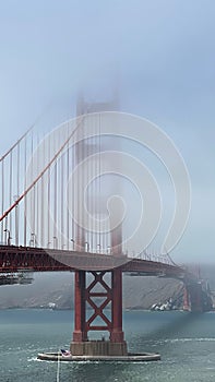 Aerial view of the iconic  Golden Gate Bridge shrouded in a dense fog