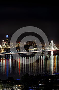 Aerial view of the iconic San Francisco-Oakland Bay Bridge at night, illuminated by city lights