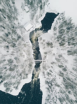 Aerial view of Icy river flowing through a beautiful snowy winter scenery in Oulanka National Park. Finland. photo