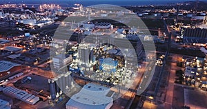 Aerial view of illuminated chemical process plant near Spanish town of Salou at twilight