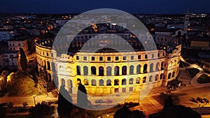 Aerial view of the illuminated Colosseum at night in Rome, Italy