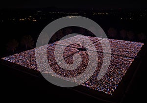 Aerial View of Illuminated Crowd at Night