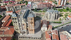 Aerial view of impressive Astorga Catholic Cathedral and Episcopal Palace on background of cityscape in summer day