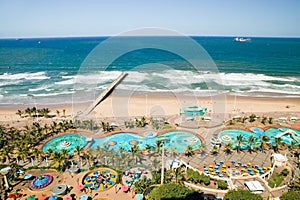 Aerial view of Indian Ocean, white sandy beaches, pool and ocean pier in the town center of Durban, South Africa
