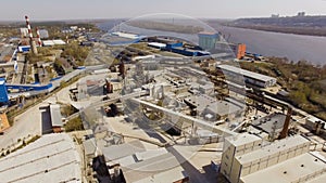 Aerial view industrial area with the plant, factories, warehouses, hangars on the river