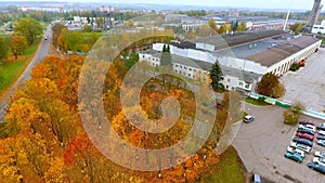 Aerial view of industrial building at autumn landscape. Modern factory building