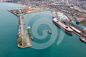 Aerial view industrial cargo and oil port with ship tankers vessel loading in gas and oil terminal station refinery