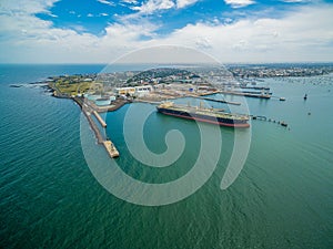 Aerial view of industrial docks and nautical vessel at Yarra river mouth. Williamstown, Melbourne, Australia.