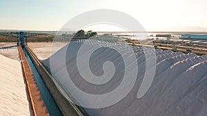 Aerial view of industrial extraction of salt in the desert, pile of salt.