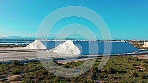 Aerial view of industrial extraction of salt in the desert, pile of salt.