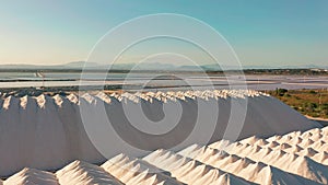 Aerial view of industrial extraction of salt in the desert, pile of salt.