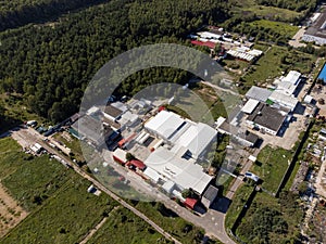 Aerial view of industrial factory complex in a green landscape