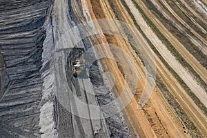 Aerial view of industrial mineral open pit mine. Opencast mining quarry with lots of machinery at work. Drone view from above