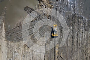 Aerial view of industrial mineral open pit mine. Opencast mining quarry with lots of machinery at work. Drone view from above