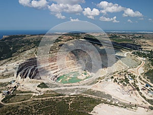 Aerial view industrial of opencast mining quarry with lots of machinery at work - extracting fluxes for the metal