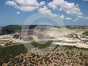 Aerial view industrial of opencast mining quarry with lots of machinery at work - extracting fluxes for the metal