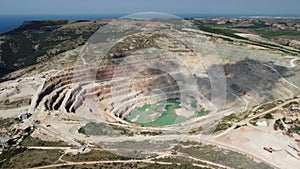 Aerial view industrial of opencast mining quarry with lots of machinery at work - extracting fluxes for the metal