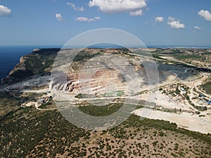 Aerial view industrial of opencast mining quarry with lots of machinery at work - extracting fluxes for the metal