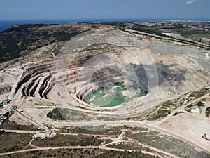 Aerial view industrial of opencast mining quarry with lots of machinery at work - extracting fluxes for the metal