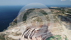 Aerial view industrial of opencast mining quarry with lots of machinery at work - extracting fluxes for the metal