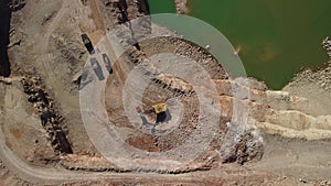 Aerial view of industrial opencast mining quarry with lots of machinery at work - extracting fluxes for the metal