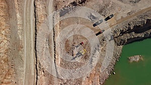 Aerial view of industrial opencast mining quarry with lots of machinery at work - extracting fluxes for the metal