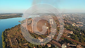 Aerial view of the Industrial Plant with Smoking Pipes near the City. Industrial zone