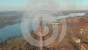 Aerial view of the Industrial Plant with Smoking Pipes near the City. Industrial zone