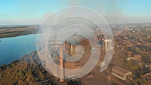 Aerial view of the Industrial Plant with Smoking Pipes near the City. Industrial zone