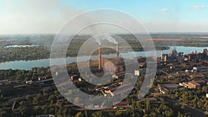 Aerial view of the Industrial Plant with Smoking Pipes near the City. Industrial zone