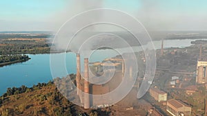 Aerial view of the Industrial Plant with Smoking Pipes near the City. Industrial zone