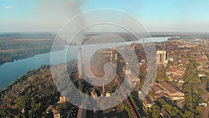 Aerial view of the Industrial Plant with Smoking Pipes near the City. Industrial zone