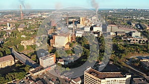 Aerial view of the Industrial Plant with Smoking Pipes near the City. Industrial zone