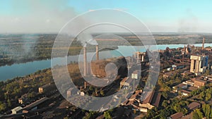 Aerial view of the Industrial Plant with Smoking Pipes near the City. Industrial zone