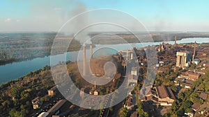 Aerial view of the Industrial Plant with Smoking Pipes near the City. Industrial zone