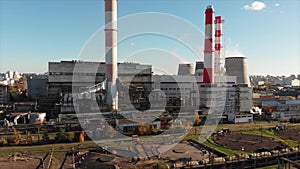 Aerial view of the Industrial Plant with Smoking Pipes near the City. Industrial zone. View from the drone to the