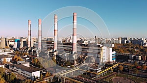 Aerial view of the Industrial Plant with Smoking Pipes near the City. Industrial zone. View from the drone to the