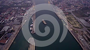 Aerial view of an industrial seaport in northern Italy. Constructions, technologies and infrastructure of a port.