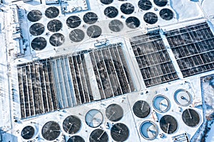 Aerial view of industrial sewage treatment plant with steam evaporation in winter time