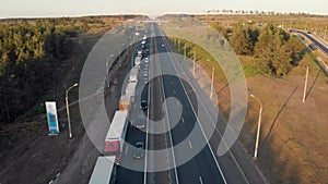 Aerial view. Intercity highway section. Congestion on the road. Cars and wagons are standing in a long traffic jam. Slow