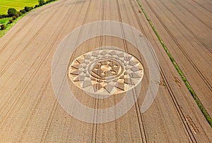 Aerial view of an intricate geometric crop circle formation in a wheat field in Wiltshire, England