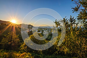 Aerial view of Ischia Island, Italy. Sunset over hills and town