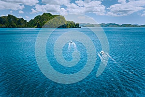 Aerial view of island hopping boats on the way to tour route abound picturesque archipelago. El Nido, Palawan
