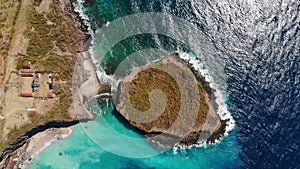 Aerial view of island with rocks and blue ocean