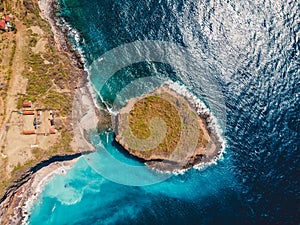 Aerial view of island with rocks and blue ocean. Bali