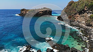 Aerial view of island with rocks, stones and blue ocean