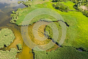 Aerial view of islands with lush greenery in a freshwater river in summer. European landscape